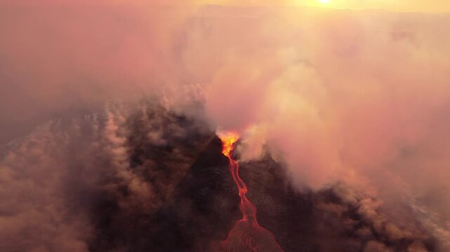Aerial view of the Litli-Hrutur volcanic eruption with glowing lava flows and thick volcanic smoke rising into the sky in Grindavik, Grindavikurbaer, Iceland.