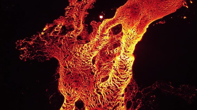 Aerial view of the Litli-Hrutur volcanic eruption showing glowing molten lava flowing across the dark volcanic landscape in Grindavik, Grindavikurbaer, Iceland.