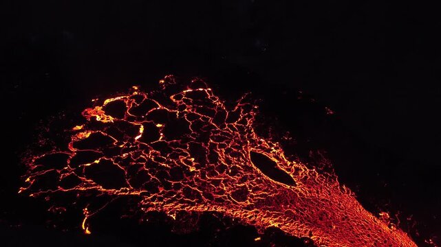 Aerial view of glowing lava flows from the Litli-Hrutur volcanic eruption at night in Grindavik, Grindavikurbaer, Iceland.