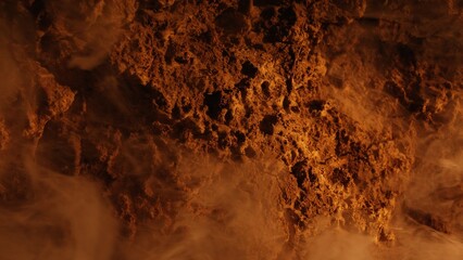 Obraz premium Intense smoke rises from porous volcanic rocks illuminated by glowing orange light in a barren desolate landscape