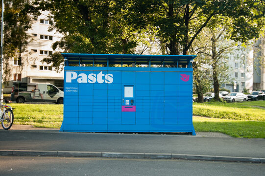 Riga, Latvia - July 14, 2026: The photo shows a blue Latvijas Pasts parcel machine in a residential area