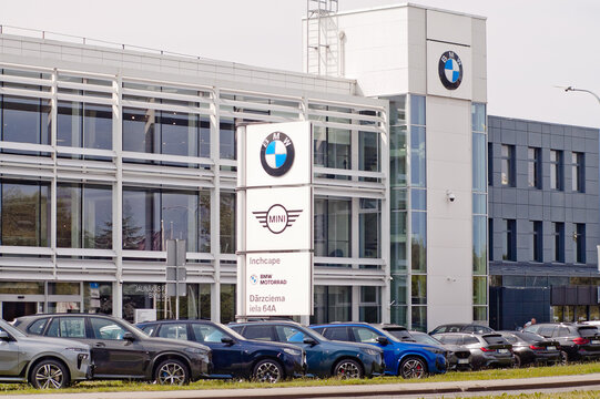 Riga, Latvia - July 15, 2026: The photo shows new BMW cars with a car dealership building and a billboard with the BMW logo in the background