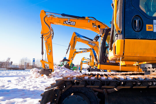 Riga, Latvia - February 8, 2026: Close-up of a JCB crawler excavator in winter near a car dealership