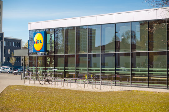 Riga, Latvia - April 29, 2026: Pictured is a new Lidl store with a lawn and a pedestrian walkway in the foreground