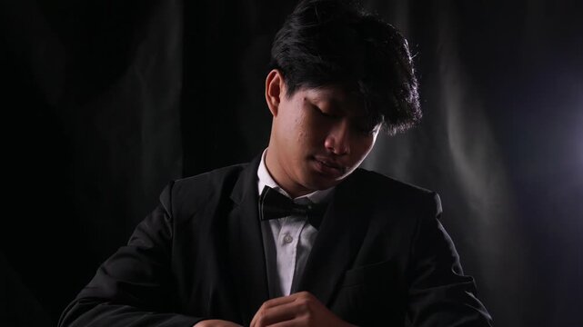 Mafia boss in a tuxedo holds a bag of illegal white powder and tastes it to test the purity. Concept of drug cartel, narcotics trafficking, and underworld criminal syndicate.
