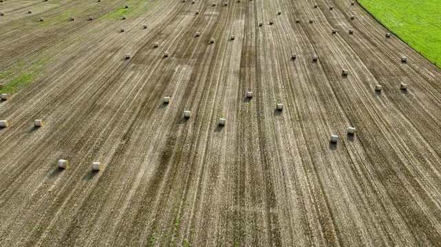 Aerial drone flying forward over hay bales Ireland
