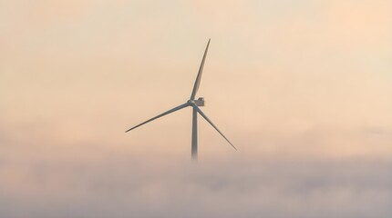 Fototapeta premium Majestic Wind Turbine Emerging Through Dense Morning Fog in a Dramatic Renewable Energy Landscape Scene