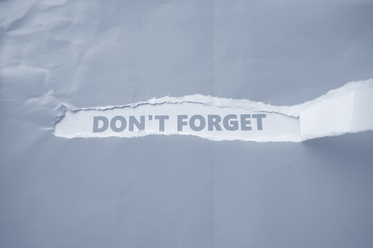 The words "DONT FORGET" were written on the back of that torn piece of paper&mdash;a phrase serving as a reminder of something important. It is often placed in strategic locations so that it catches the eye