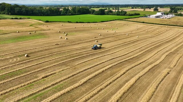 Aerial panoramic view of hay baling in rolling Irish countryside