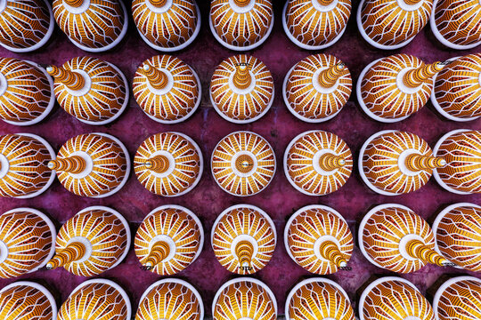 Aerial view of the 201 Gombuj Masjid featuring rows of intricate golden domes against a vibrant purple roof surface in Tangail District, Dhaka Division, Bangladesh.