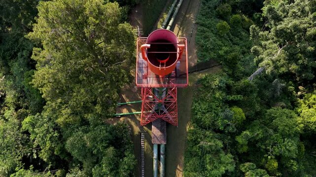 Aerial view of the Ketenger water penstock surrounded by dense tropical forest in Baturaden, Central Java, Indonesia.