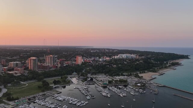 Aerial View of McKinley Marina and Milwaukee Lakeshore at Sunset&rdquo;  Aerial view of McKinley Marina filled with boats along the Lake Michigan shoreline in Milwaukee, Wisconsin at sunset, with the coastl