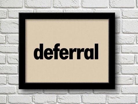 Framed word deferral on white brick wall. Minimalist graphic art. Concept for delay postponement procrastination or extended deadlines. Modern interior decor.