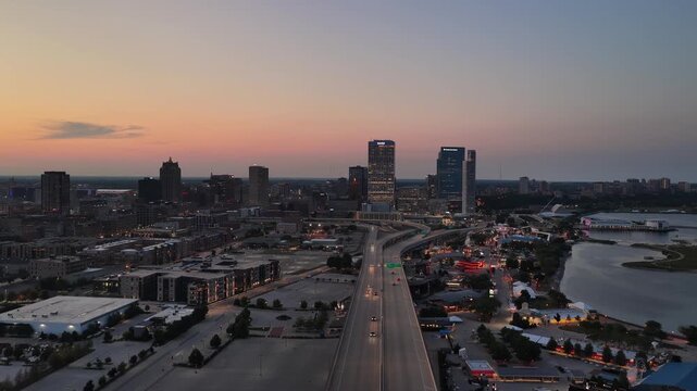  Aerial View of Milwaukee Freeway Leading to Downtown Skyline at Dusk&rdquo; on August 3  Aerial view of a highway leading toward downtown Milwaukee, Wisconsin at dusk, with the illuminated skyline, harbor,