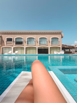 Legs view of female having fun by swimming pool - Young woman enjoying luxury hotel resort in summer vacation