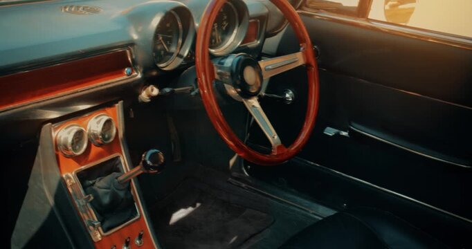 Car interior - classic vintage luxury motor vehicle steering wheel. Sports car with retro style dashboard.