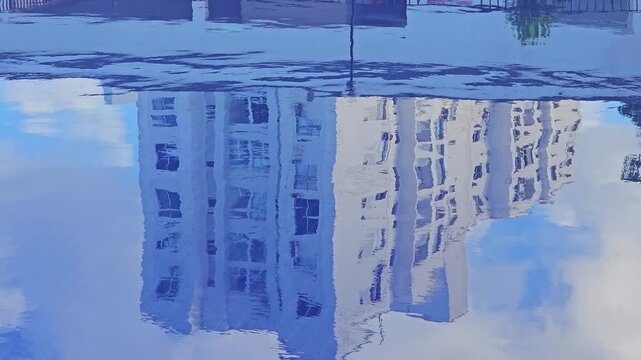 Reflection of Buildings and Clouds in the Water of a Residential Swimming Pool in a Gated Community
