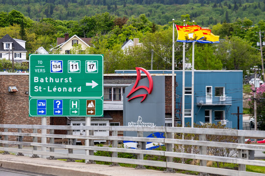 Gaspesie, Quebec, 06 June 2026 : A green highway sign displays directions to Bathurst and Saint Leonard, with New Brunswick route numbers.