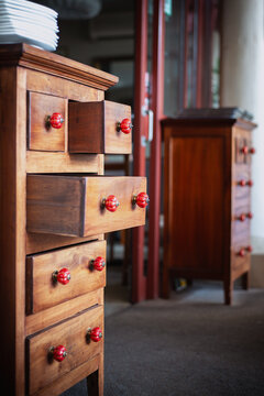 Wooden drawers with colorful knobs create a warm and inviting atmosphere in a cozy interior space - vertical