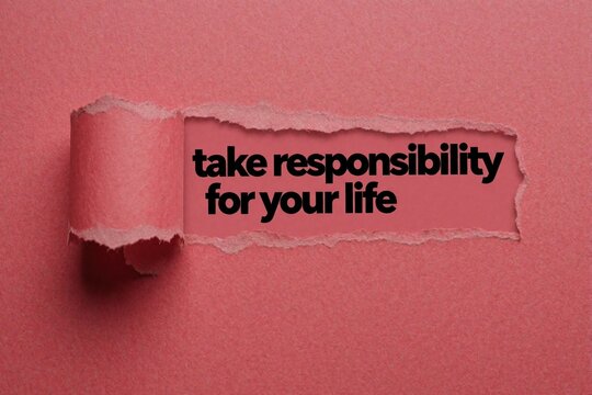Text message take responsibility for your life appears on pink background showing torn paper. Message encourages personal growth and self-empowerment. Focus on choice and action.