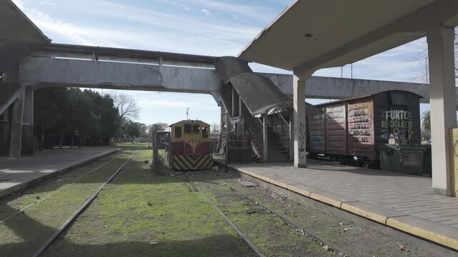 Platforms, footbridge, and recreational handcar at the historic Meridiano V railway station in La Plata, Buenos Aires, Argentina. D-Log M, 10-bit color, flat log profile.