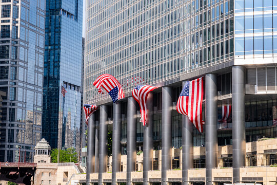American flags fly outside Trump Tower Chicago, a namesake property fueling political scrutiny over presidential business ties and government optics. July 2026