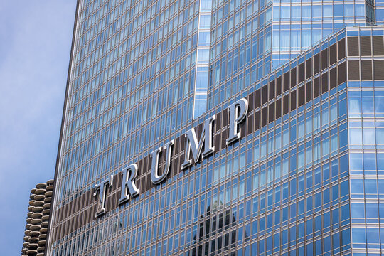 Metallic Trump sign on the facade of Trump International Hotel and Tower along the riverwalk in downtown Chicago, a site of recurring anti-Trump protests. July 2026
