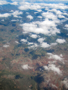 Aerial view of clouds floating over vast land area