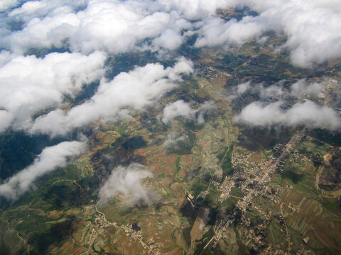 Aerial view of clouds floating over vast land area