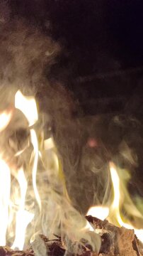 Bright flames burning against a dark background, showcasing intense fire, glowing embers, and dramatic contrast.