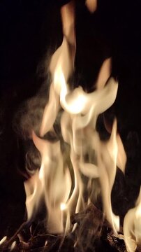 Bright flames burning against a dark background, showcasing intense fire, glowing embers, and dramatic contrast.