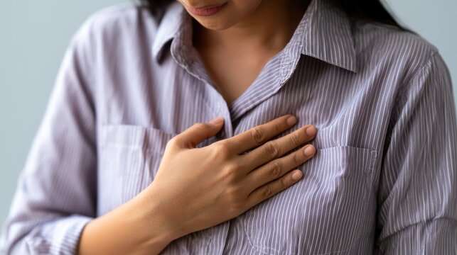 hand hold chest with heart attack symptoms, have chest pain caused by heart disease, leak, dilatation, enlarged coronary heart, press on the chest with a painful expression