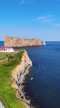 Aerial drone view of Perc&eacute; Rock and rugged coastline in Gasp&eacute;sie, Quebec.