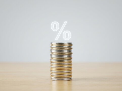 A Tall Stack Of Shiny Metallic Coins Featuring A Glowing Percentage Symbol