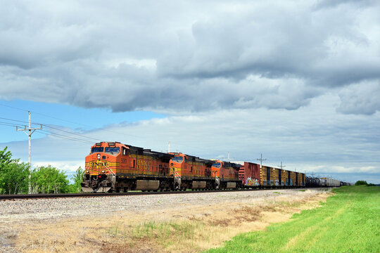 Three locomotive units, arranged elephant style, provide power for a Burlington Northern Santa Fe westbound merchandise freight train as it passes through north central Illinois.
