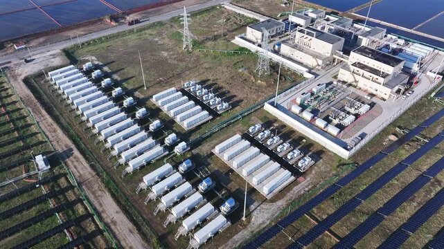 Aerial view of photovoltaic power station with energy storage units and substation facilities