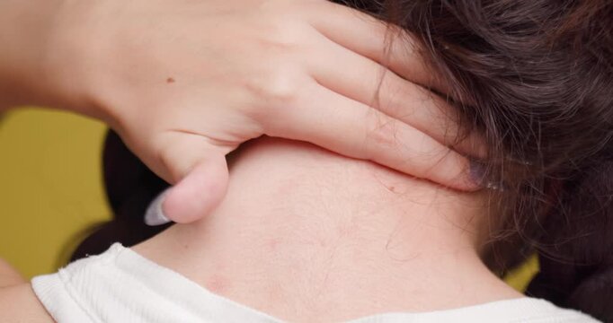 Close-up view of a young woman holding her neck, intimate and detailed portrait