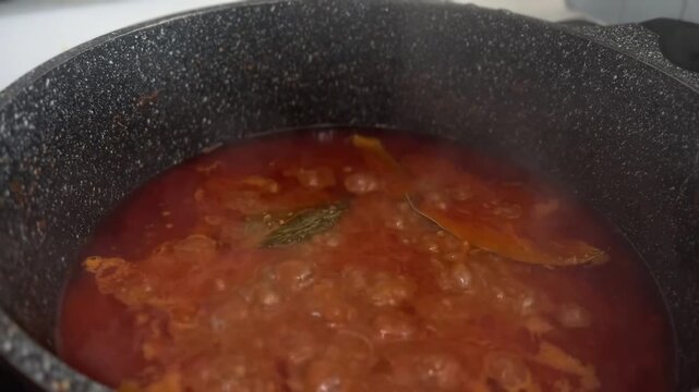 Simmering ground beef in red tomato sauce