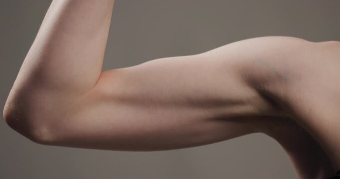 Close-up view of a human arm and elbow, highlighting skin texture and muscle tone