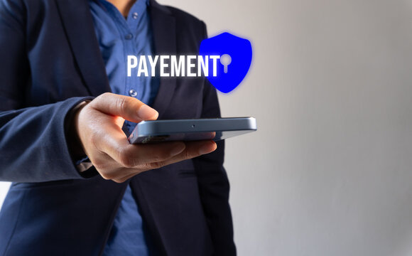 Hand holding mobile device displaying payment symbol