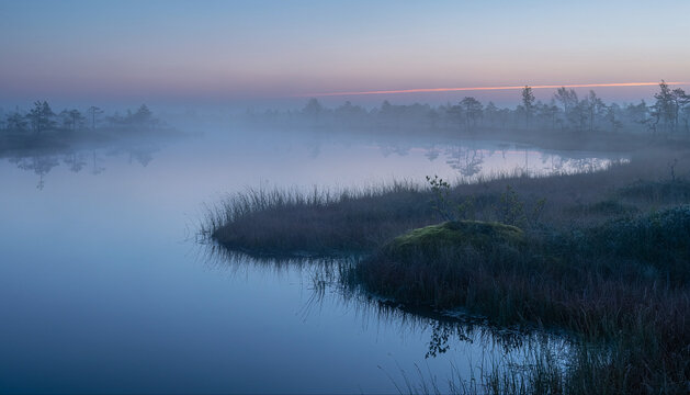 title": "Serene Morning Landscape: Misty Lake Reflections and Tranquil Forest", "description": "This captivating image captures the serene beauty of a misty lake at dawn, reflecting the tranquil fore