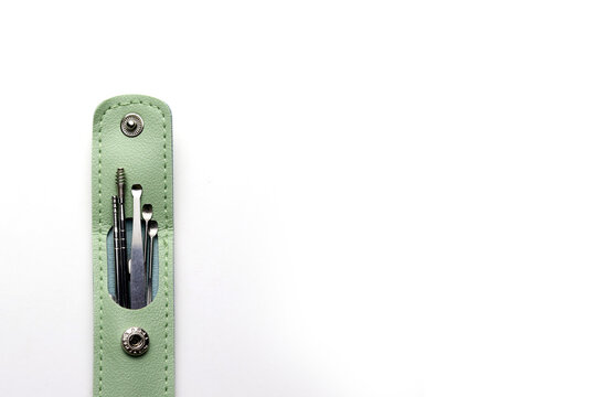 Metal ear tools in mint green leather