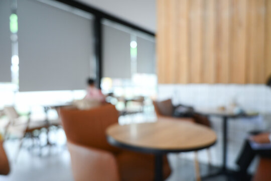softy blurred view of a modern cafe or lounge interior featuring comfortable chair and round table