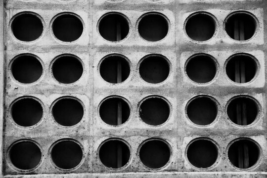Old gray brock cement with black circle hole background