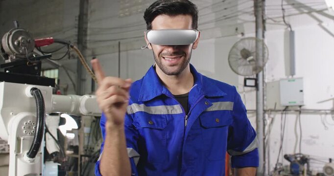 Professional industrial engineer using a virtual reality headset control and operate an experimental automation robotic arm machine. High Tech Industry 4.0 Factory. Innovation and futuristic concept.