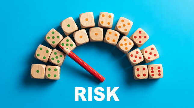 Wooden dice arranged as a risk gauge with a red pencil indicator
