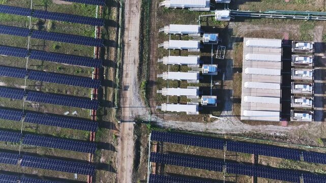 Aerial view of solar photovoltaic arrays and inverter equipment installations on the ground