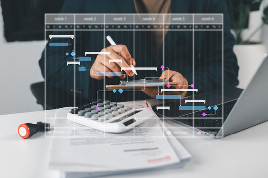 Business professional managing a digital Gantt chart for project scheduling, workflow and task planning on Laptop.