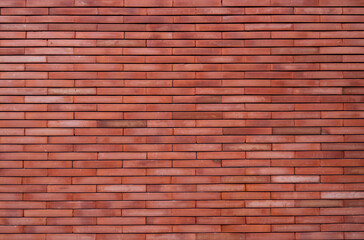 Fototapeta premium Modern red brick wall texture with clean horizontal masonry pattern, architectural construction background featuring natural clay material for graphic design, website layouts and commercial use.