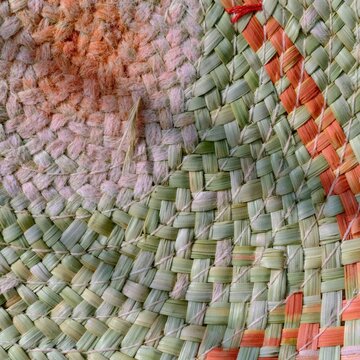 Woven palm straw texture with spiral coils and natural fibers creates a weathered, tactile surface for heritage craft design and material study